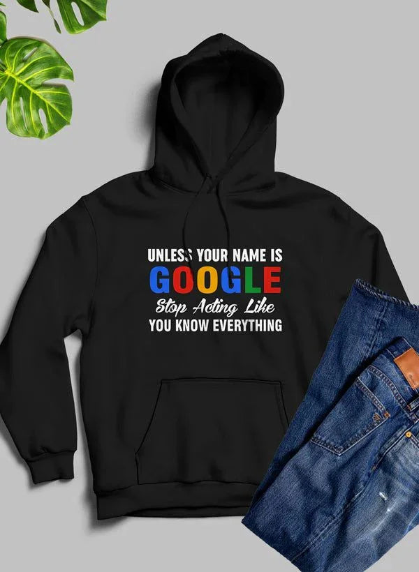 Black hoodie with 'Unless your name is Google stop acting like you know everything' print, paired with blue jeans on a gray background with green leaves.