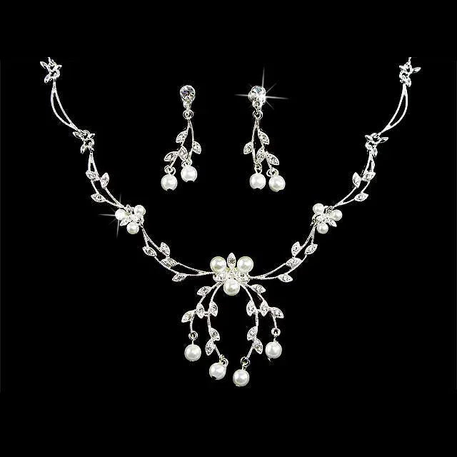 Elegant pearl and crystal floral necklace and earring set on black background