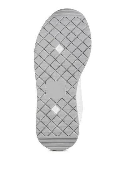Gray sneaker sole with diamond pattern tread and central textured area, isolated on white