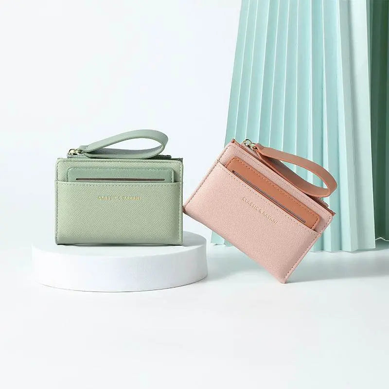 Simple elegant solid color wallets for women in green and pink on white background.