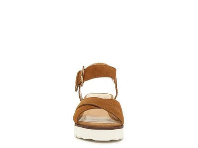 Brown suede sandal with white platform sole and ankle strap, front view on white background