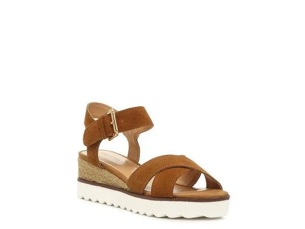 Brown suede wedge sandal with ankle strap and white sole on plain background