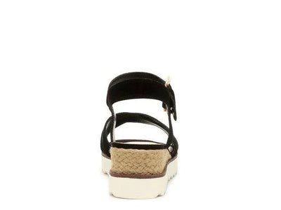 Back view of black platform sandal with woven jute heel and white rubber sole on white background