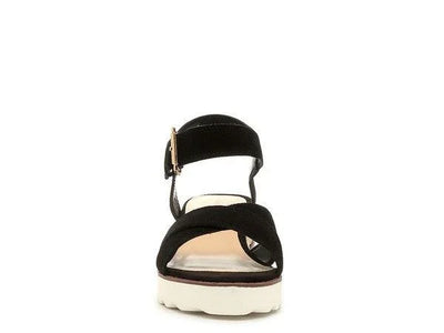 Black suede platform sandal with white sole and ankle strap, front view.