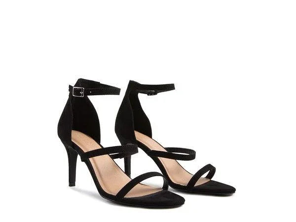 Black suede ankle strap heeled sandals with open toe and stiletto heel on white background