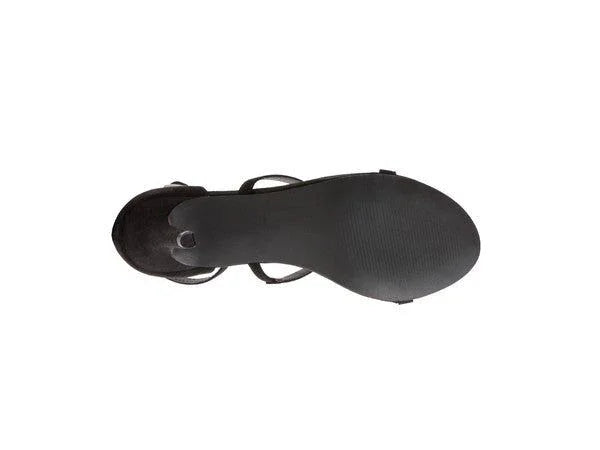 Black women's sandal with a flat rubber sole, viewed from the bottom on a white background