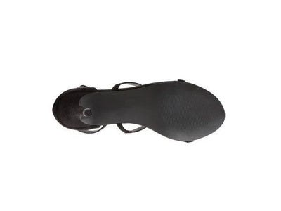 Black women's sandal with a flat rubber sole, viewed from the bottom on a white background