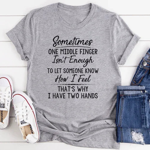 Gray graphic tee with bold sarcastic quote, paired with denim shorts and white sneakers