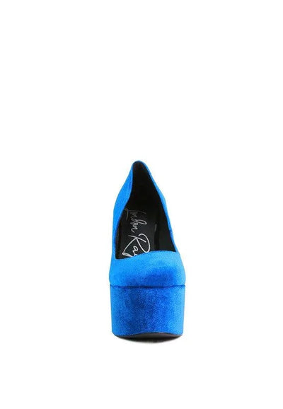 Front view of a vibrant blue suede platform high heel shoe on white background