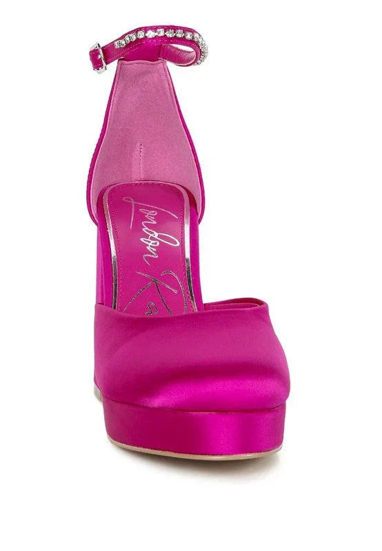 Hot pink satin platform heel with rhinestone ankle strap, women's dress shoe front view