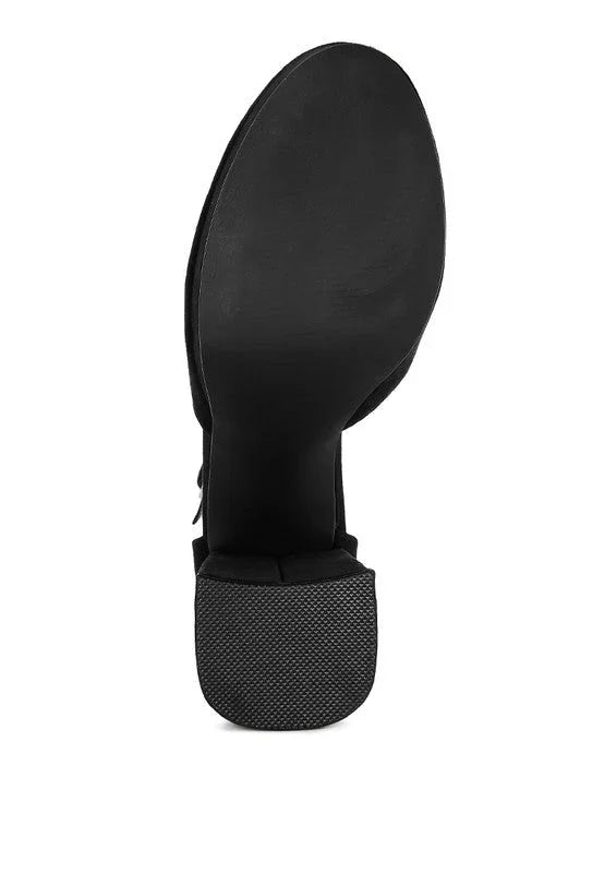 Black boot sole with textured heel, close-up on white background