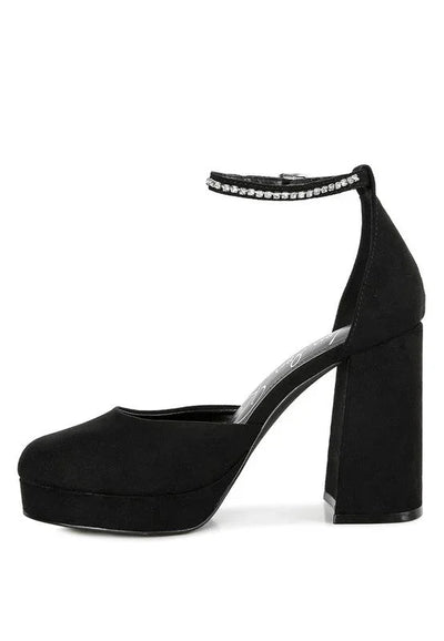 Black suede block heel platform pump with rhinestone ankle strap on white background