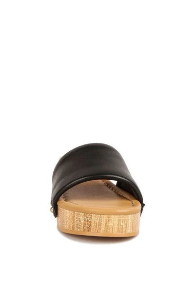 Black leather slide sandal with wooden platform sole on white background