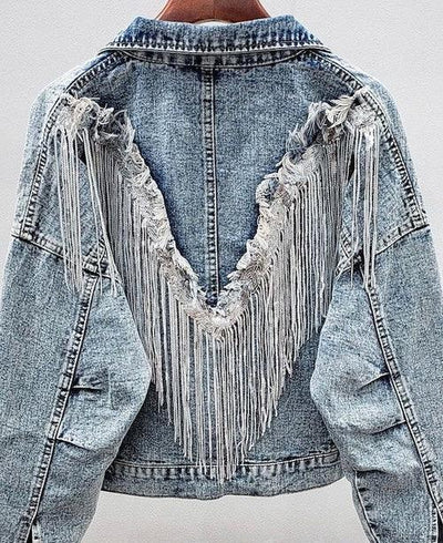Light blue denim jacket with V-shaped fringe and distressed details on the back.