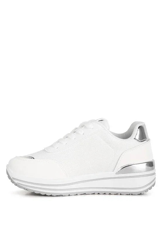 White platform sneaker with silver accents and rubber sole on white background