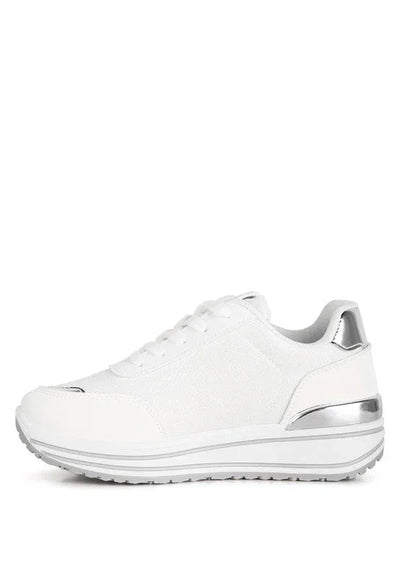 White platform sneaker with silver accents and rubber sole on white background