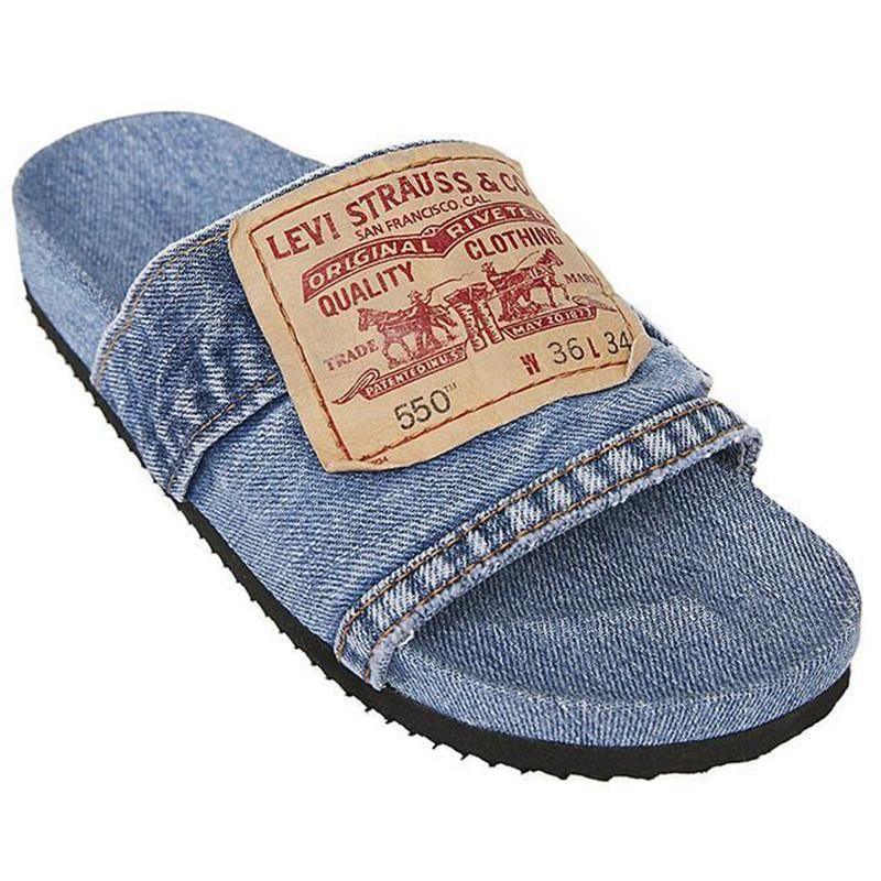 Denim slide sandal with Levi Strauss logo patch on strap and black sole