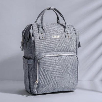 Modern light gray backpack with front zipper pocket and handles on minimalist background
