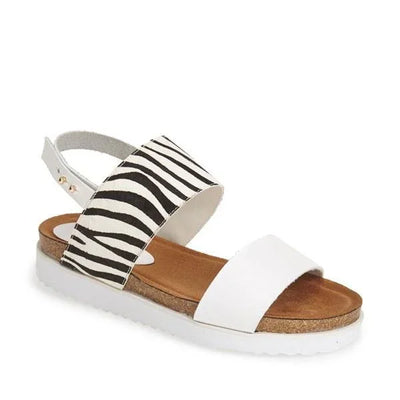 Women's sandal with white strap, zebra pattern band, cork footbed, and white sole