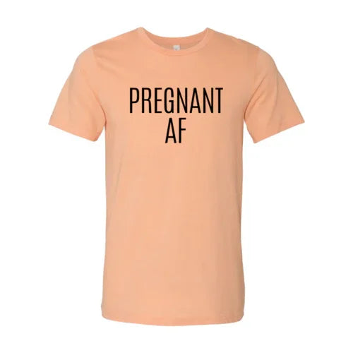 Peach color t-shirt with bold black text 'PREGNANT AF' on the front