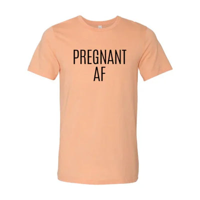 Peach color t-shirt with bold black text 'PREGNANT AF' on the front