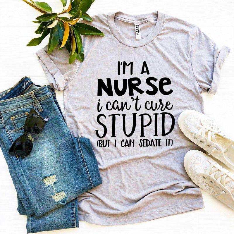 Gray nurse slogan t-shirt with jeans, white crochet sneakers, sunglasses and plant flat lay
