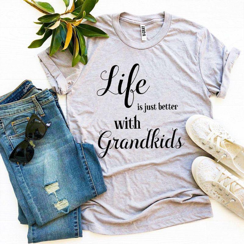 Gray t-shirt with 'Life is just better with Grandkids' text, jeans, sunglasses, white shoes