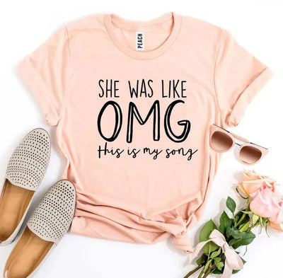 Peach graphic tee with 'She was like OMG this is my song,' sunglasses, flats, roses
