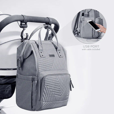 Gray diaper bag backpack with USB charging port attached to stroller handle