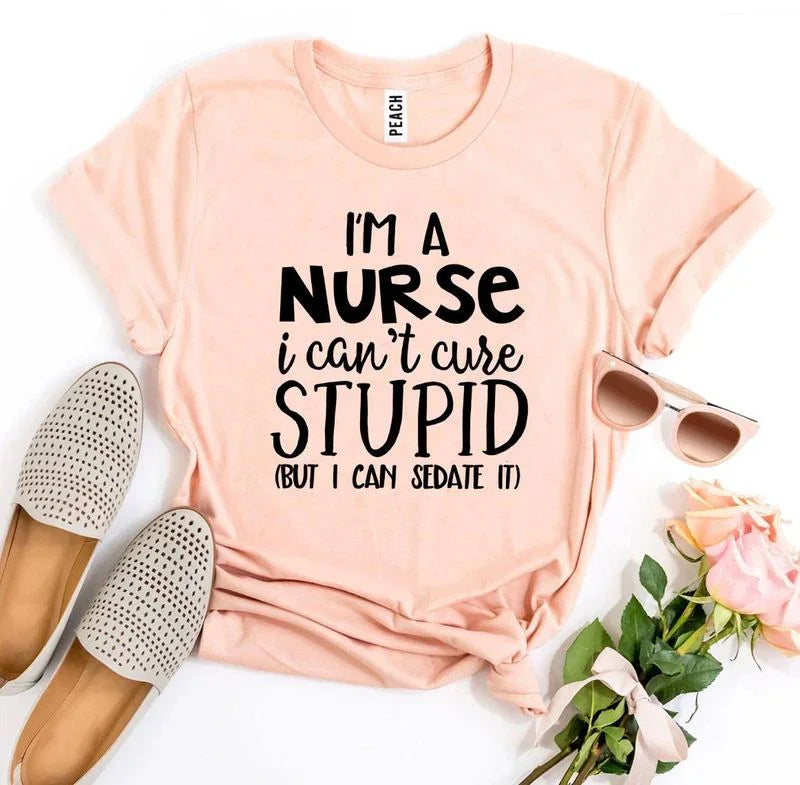 Peach nurse slogan t-shirt with 'I’m a nurse I can’t cure stupid' text, flats, sunglasses, roses