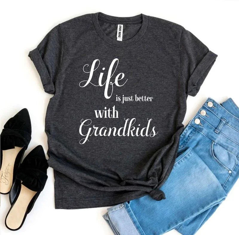 Dark gray t-shirt with 'Life is just better with Grandkids' message, blue jeans, black flats