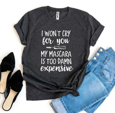Dark gray graphic tee with mascara quote, paired with blue jeans and black flats