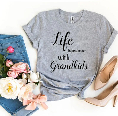 Gray t-shirt with 'Life is just better with Grandkids' text, blue jeans, flowers, nude heels