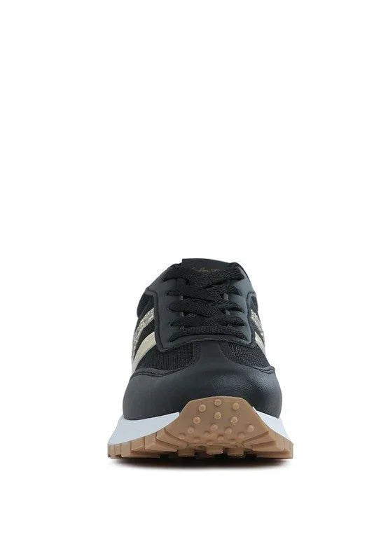 Black and beige sneaker with gum sole, front view on white background