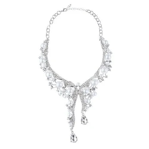 Silver statement necklace with large white pearls and crystal drops on a white background