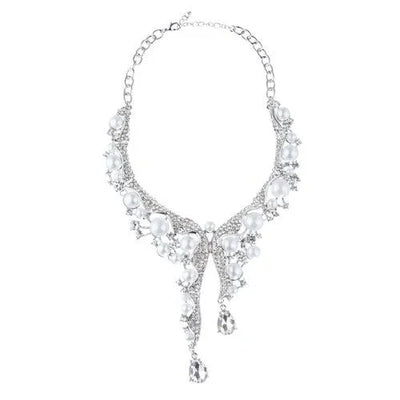 Silver statement necklace with large white pearls and crystal drops on a white background