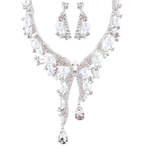 Elegant pearl and crystal necklace and earrings set on white background