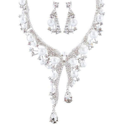 Elegant pearl and crystal necklace and earrings set on white background