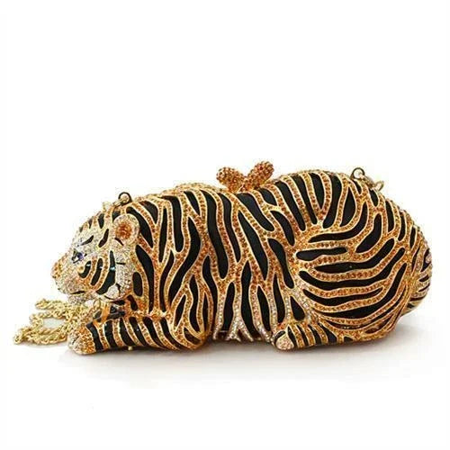 Tiger-shaped gold and black clutch purse with crystal embellishments on white background